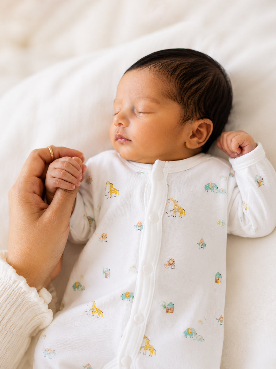 Ziva Baby Jumpsuit – White | Safari Mini Adventure Print | Knitted Cotton | Front Open Snap Button