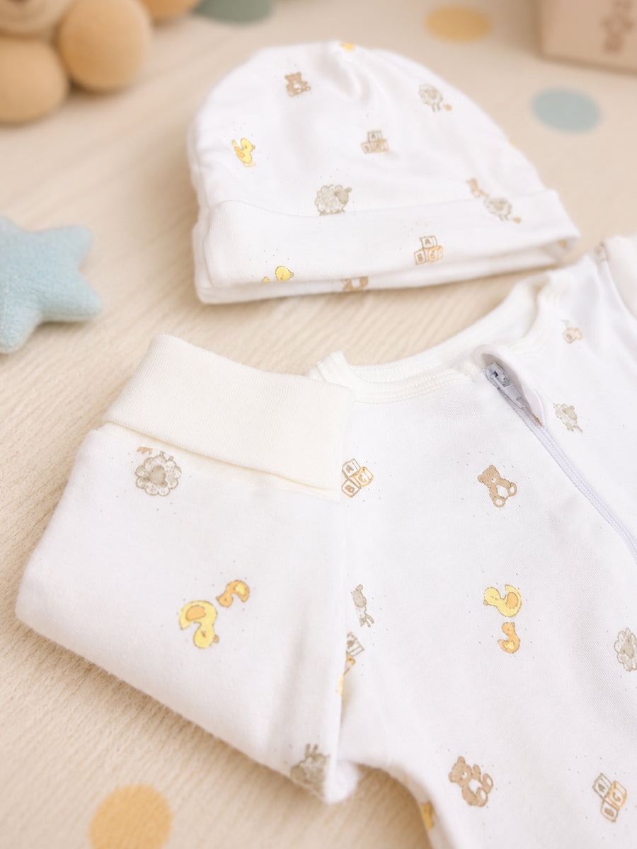 Ziva Knitted Cotton Baby Sleepsuit with Cap – Puppy Bear & Little Duck Play Print | Off White