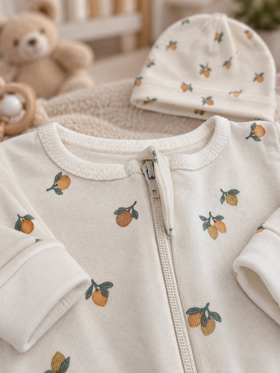 Ziva Baby Sleepsuit with Cap – Off White Tiny Orange Fruit Print | Premium Knitted Cotton | Front Zip | Fold-Over Mittens & Integrated Booties
