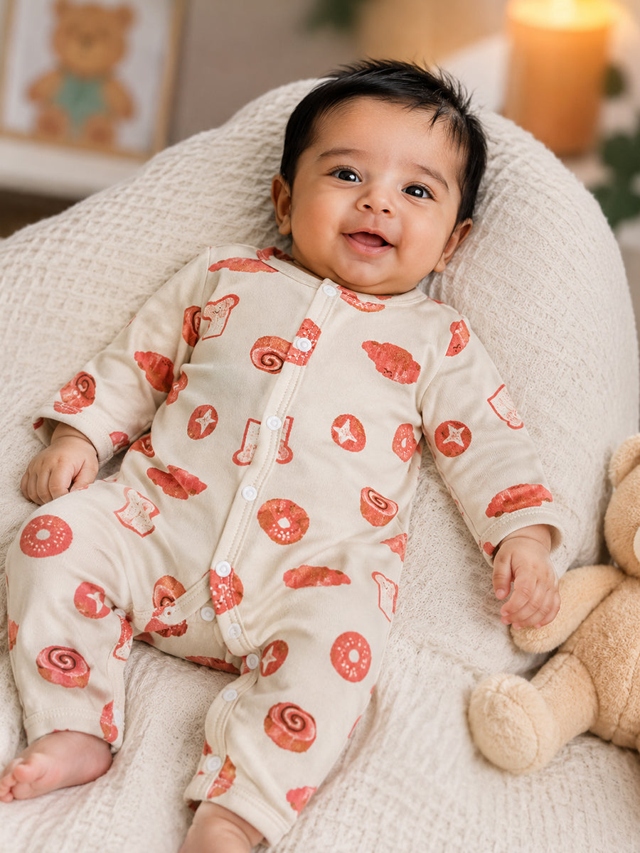 Ziva Baby Jumpsuit – Cream | Playful Bakery Print | Knitted Cotton | Front Open Snap Button