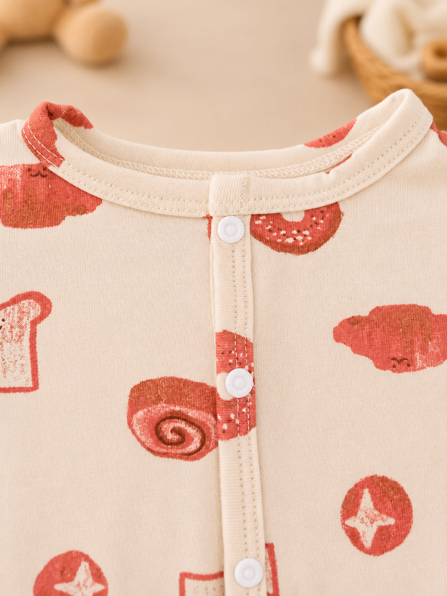 Ziva Baby Jumpsuit – Cream | Playful Bakery Print | Knitted Cotton | Front Open Snap Button