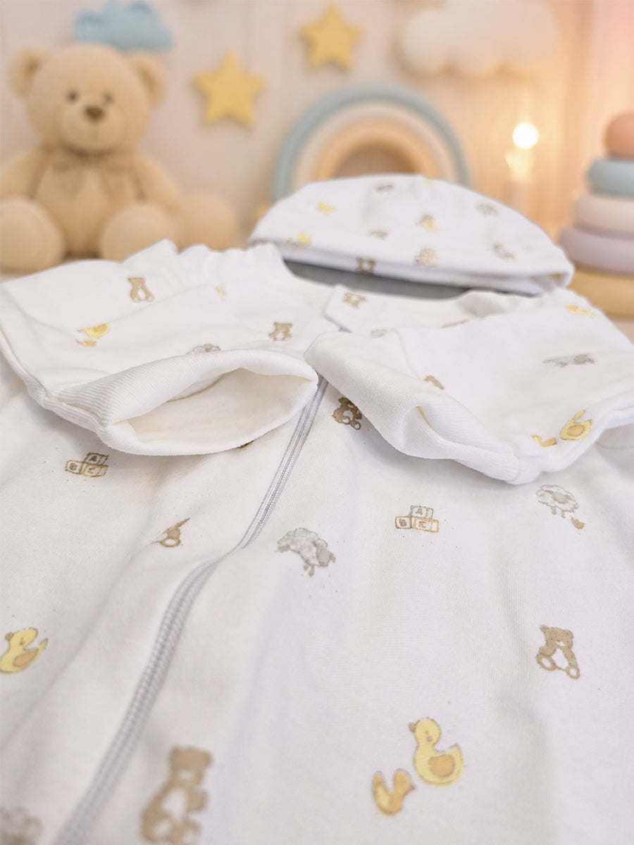 Ziva Knitted Cotton Baby Sleepsuit with Cap – Puppy Bear & Little Duck Play Print | Off White