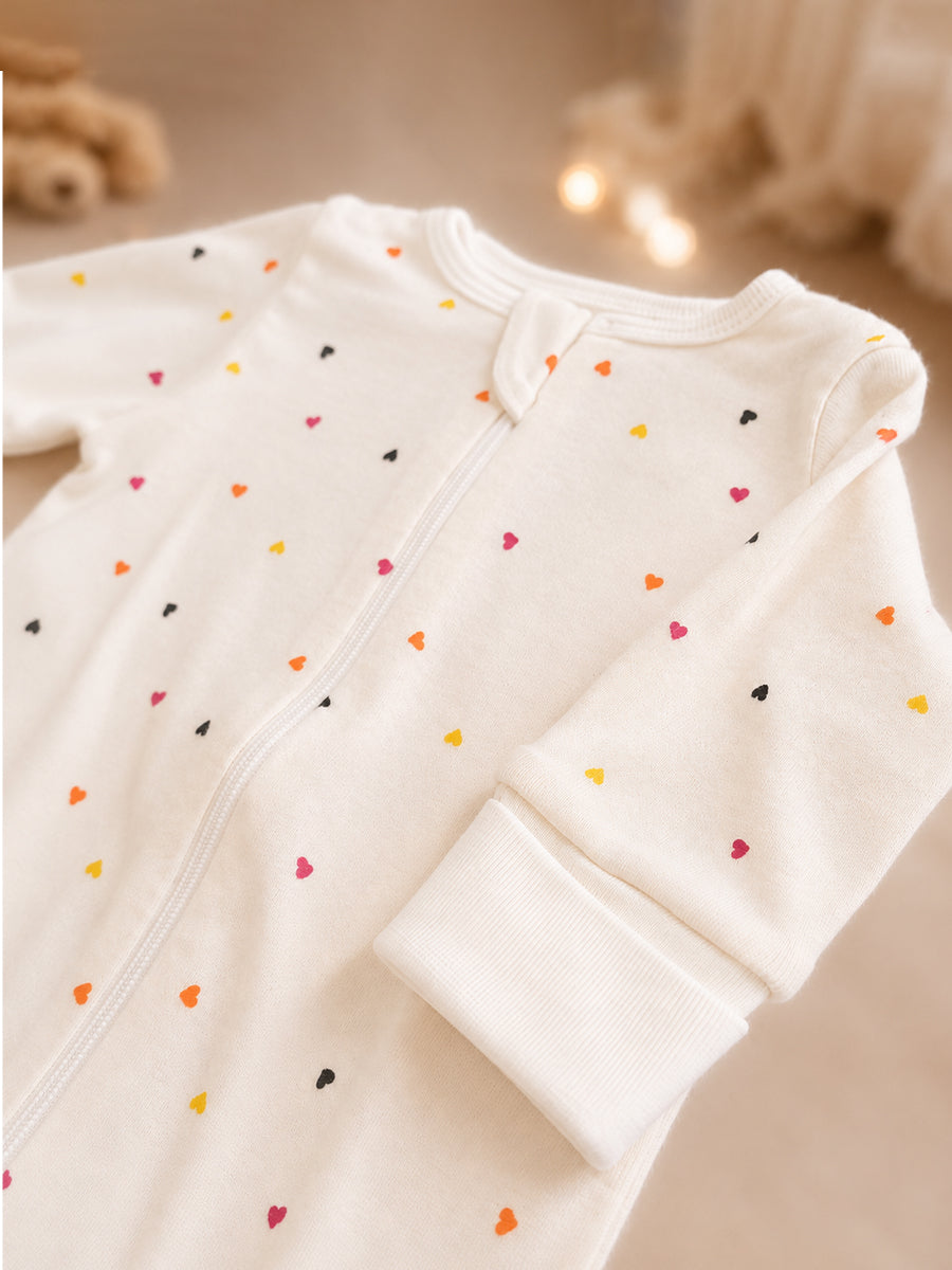 Ziva Knitted Cotton Baby Sleepsuit with Cap – Multicolor Mini Heart Print | Cream