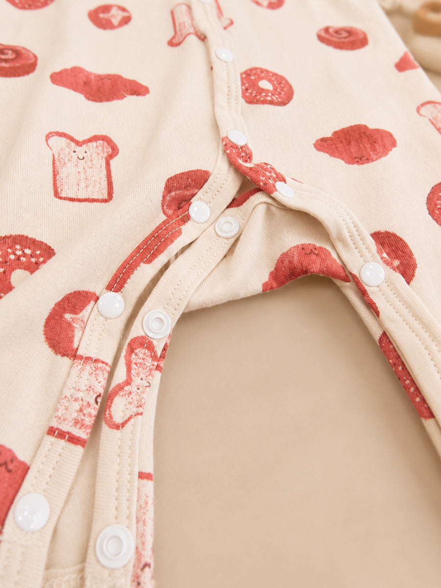 Ziva Baby Jumpsuit – Cream | Playful Bakery Print | Knitted Cotton | Front Open Snap Button