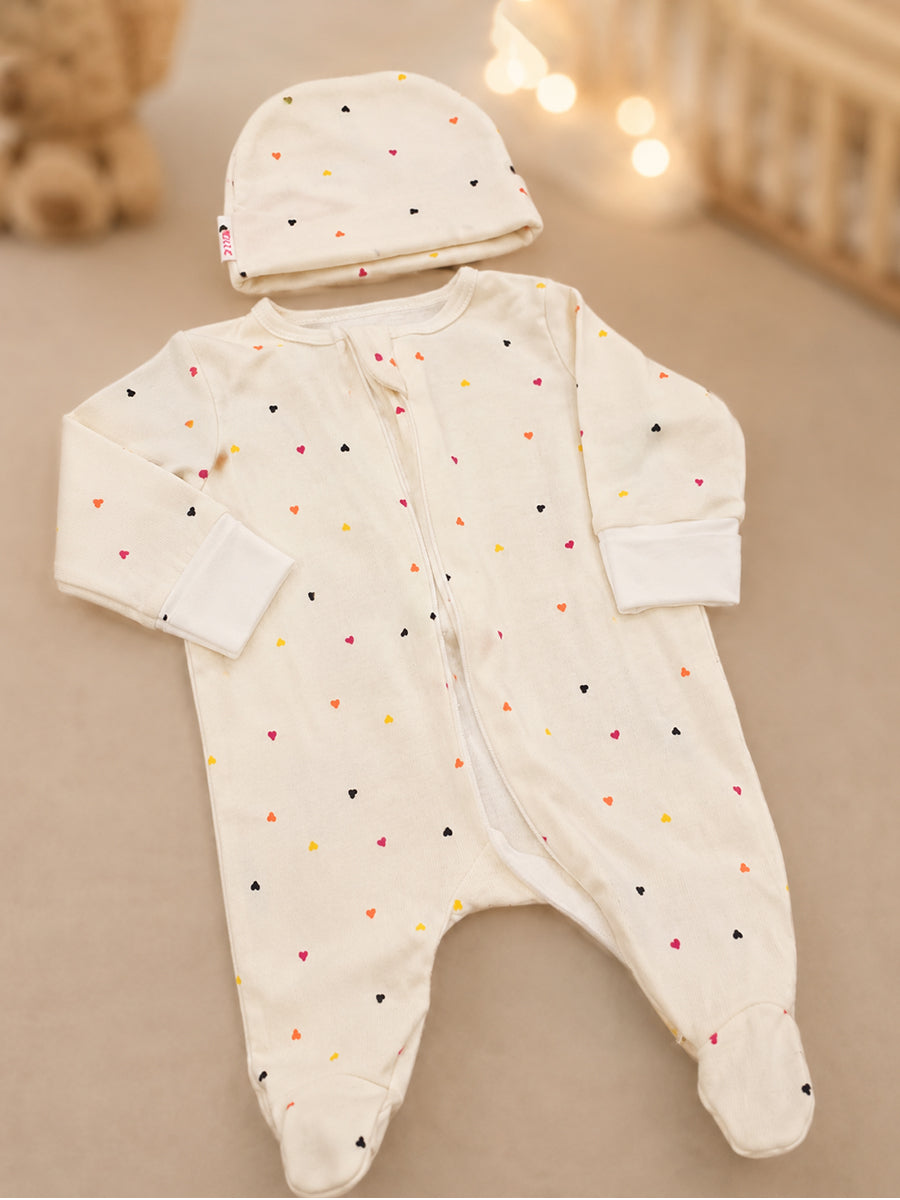 Ziva Knitted Cotton Baby Sleepsuit with Cap – Multicolor Mini Heart Print | Cream