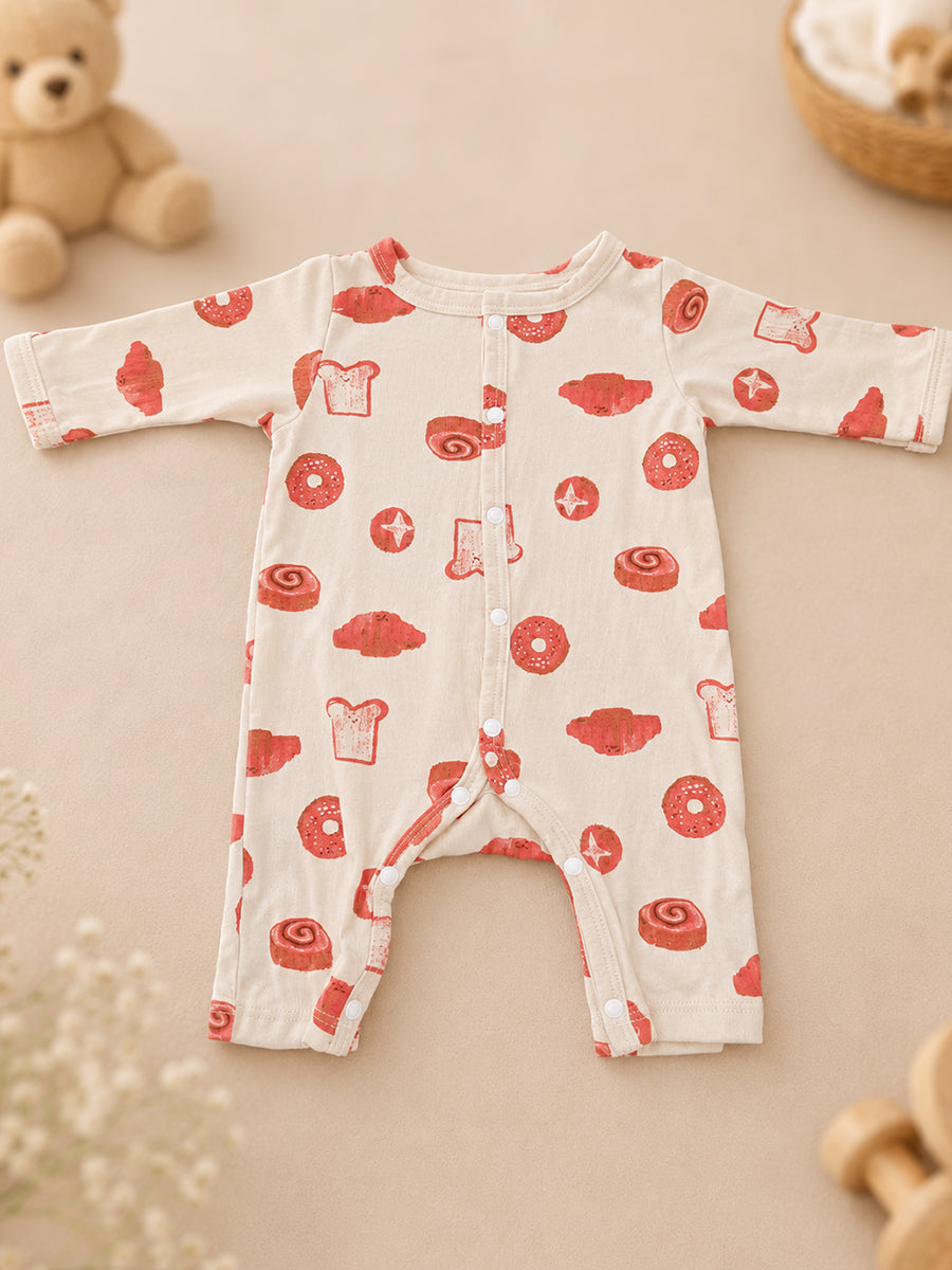 Ziva Baby Jumpsuit – Cream | Playful Bakery Print | Knitted Cotton | Front Open Snap Button