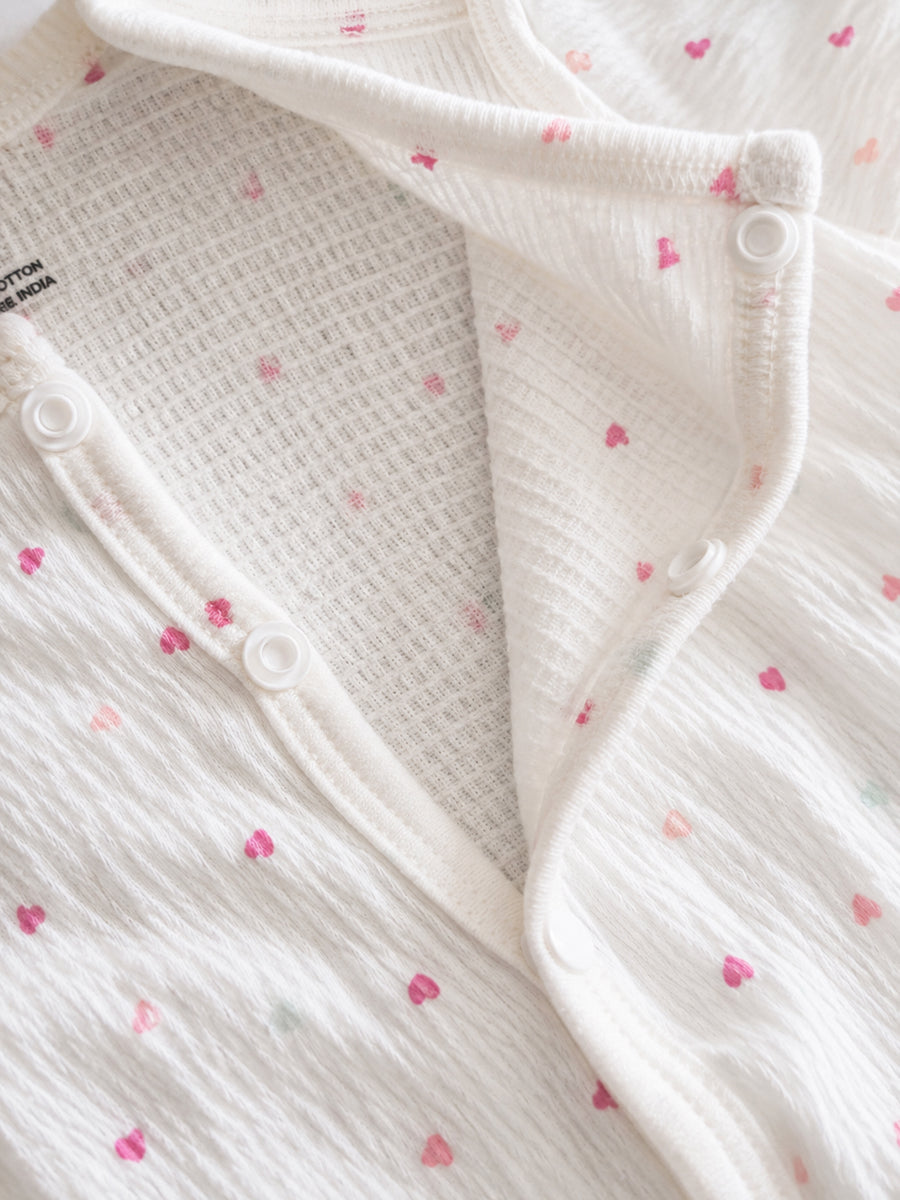 Ziva Baby Jumpsuit – Off White | Tiny Pastel Heart Sprinkle Print | Soft Waffle Knitted Cotton | Front Open Snap Button