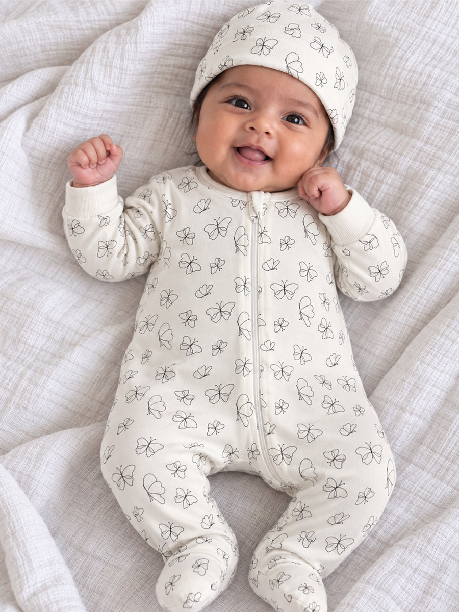 Ziva Baby Sleepsuit with Cap – Off-White Butterfly Print | Premium Knitted Cotton | Front Zip | Fold-Over Mittens & Integrated Booties